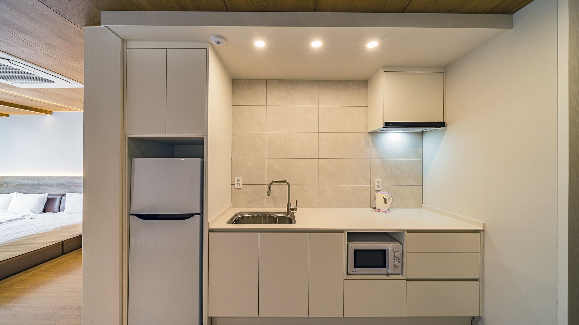 mini-fridge, microwave, electric kettle, cookware/dishes/utensils