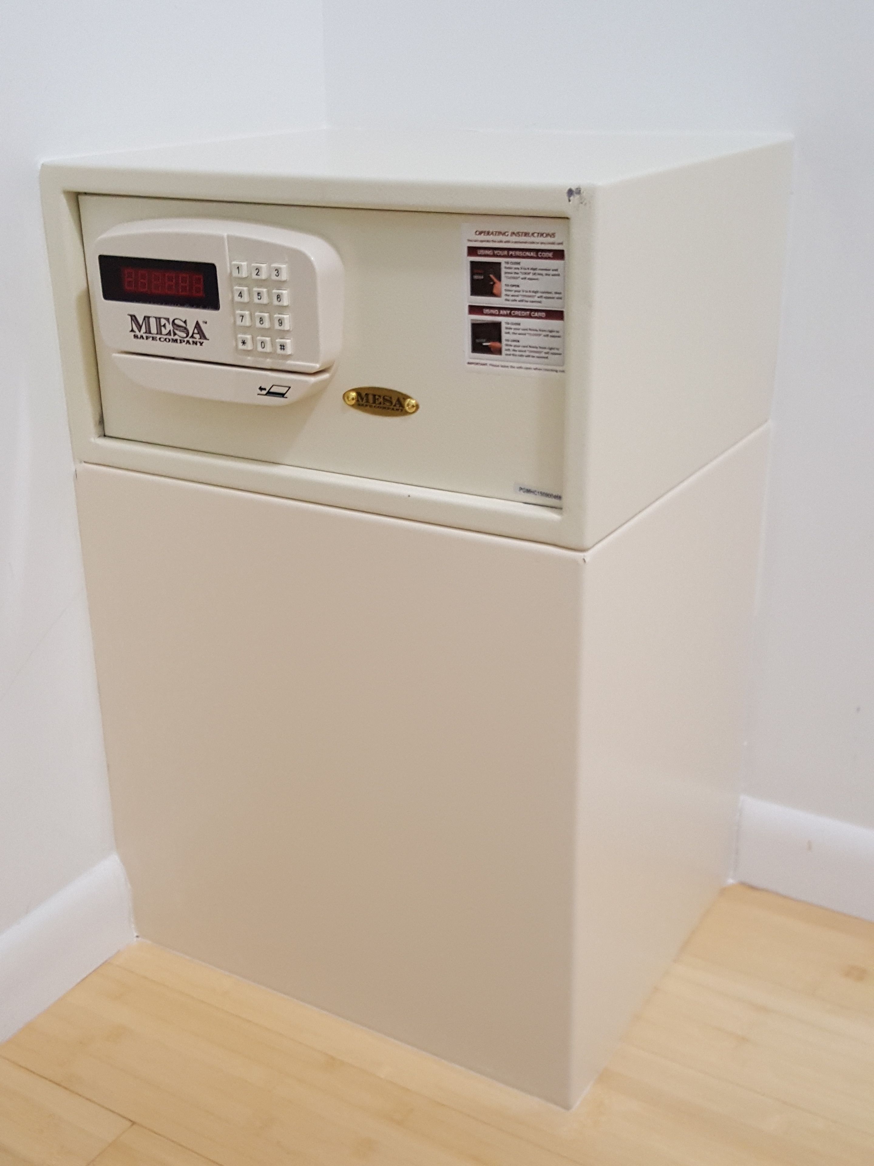 A white refrigerator with a digital display and a keypad, labeled 'MESA SAFE COMPANY'.
