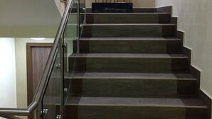 A staircase with glass railings and a bamboo plant at the top. - Hotel Castropol (Mexico City)