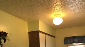 A compact kitchen with a refrigerator, microwave, stove, and sink. - Itascan Motel (Grand Rapids)