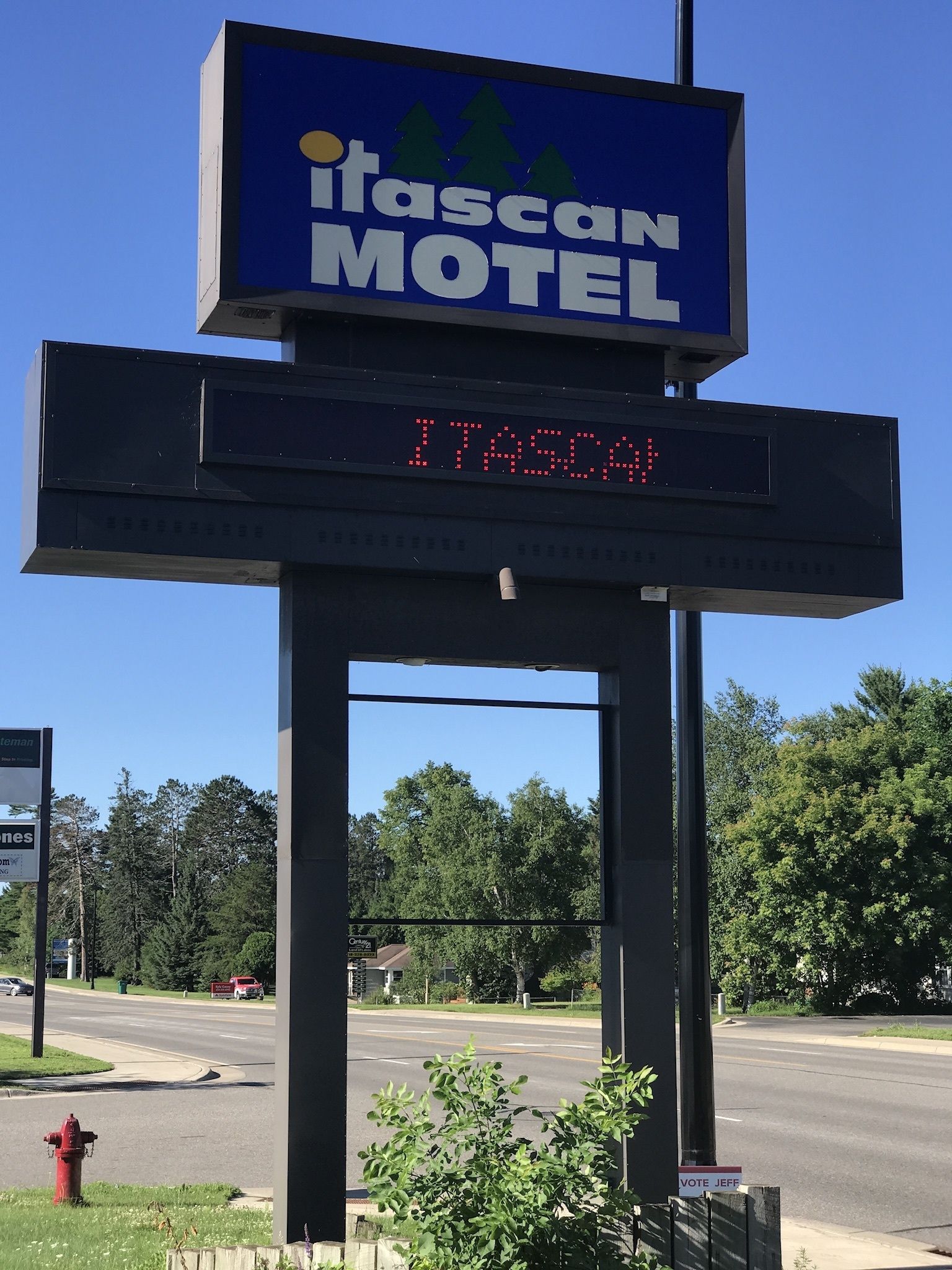 A motel sign with a digital display and a 'Vote Jeff' sign below it.