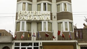 A multi-story hotel building with a sign reading "HOTEL PADAMA".