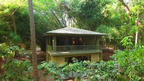 A small, single-story building with a balcony, surrounded by dense greenery. - Puerto Barillas Marina & Lodge (Usulutan)
