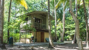 A two-story building with a balcony, surrounded by trees. - Puerto Barillas Marina & Lodge (Usulutan)
