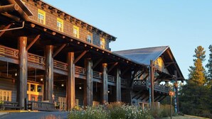 A large wooden building with multiple levels and a covered outdoor area. - Glacier Park Lodge (East Glacier Park)