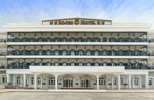 A historic hotel with a grand facade, multiple balconies, and a classic architectural style.