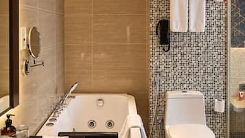 A modern bathroom with a freestanding bathtub, a toilet, and a sink.