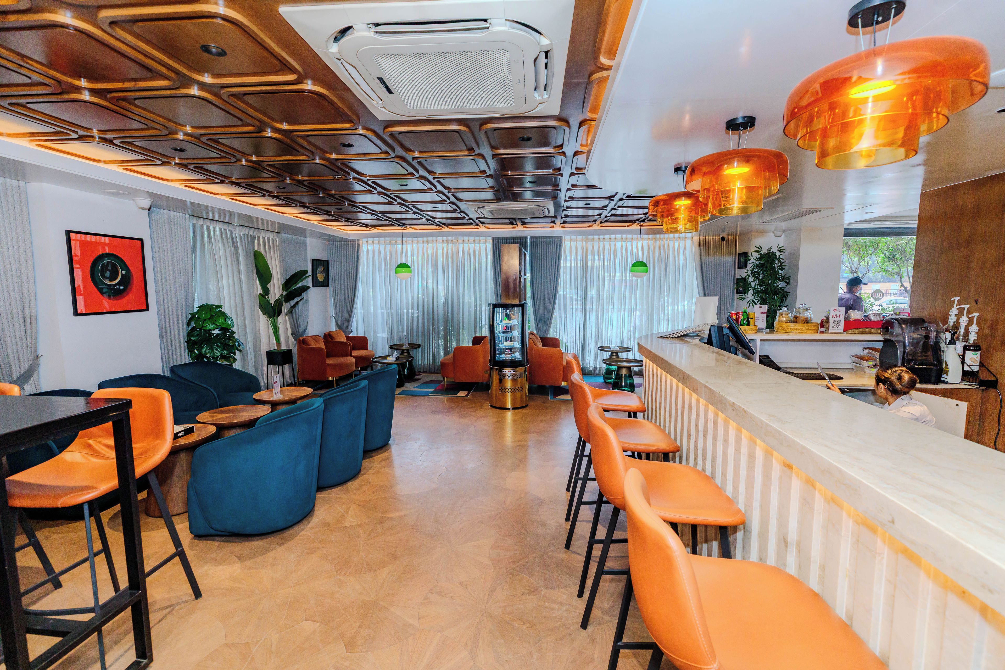 A modern interior with a bar area, seating, and a view of the outdoors.