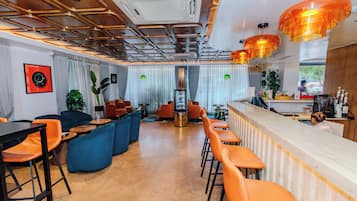 A modern interior with a bar area, seating, and a view of the outdoors.