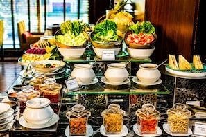 A buffet with various food options including salads, fruits, and nuts. - Best Western Plus Maple Leaf (Dhaka)