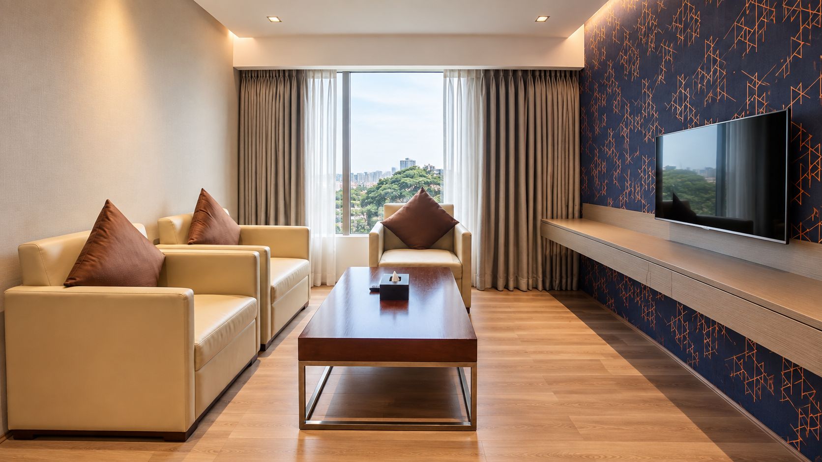 A modern living room with a sofa set, a coffee table, and a flat-screen TV mounted on the wall.