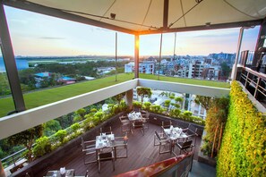 A balcony with a view of a cityscape and airport in the distance. - Best Western Plus Maple Leaf (Dhaka)