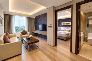 A modern hotel room with a living area, a bedroom, and a bathroom. - Best Western Plus Maple Leaf (Dhaka)
