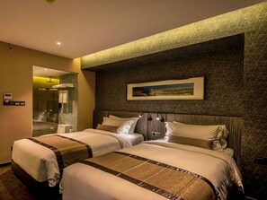 A hotel room with two beds, a shower area, and a framed picture on the wall. - Best Western Plus Maple Leaf (Dhaka)