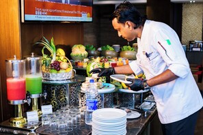 A buffet setup with various food items and beverages. - Best Western Plus Maple Leaf (Dhaka)