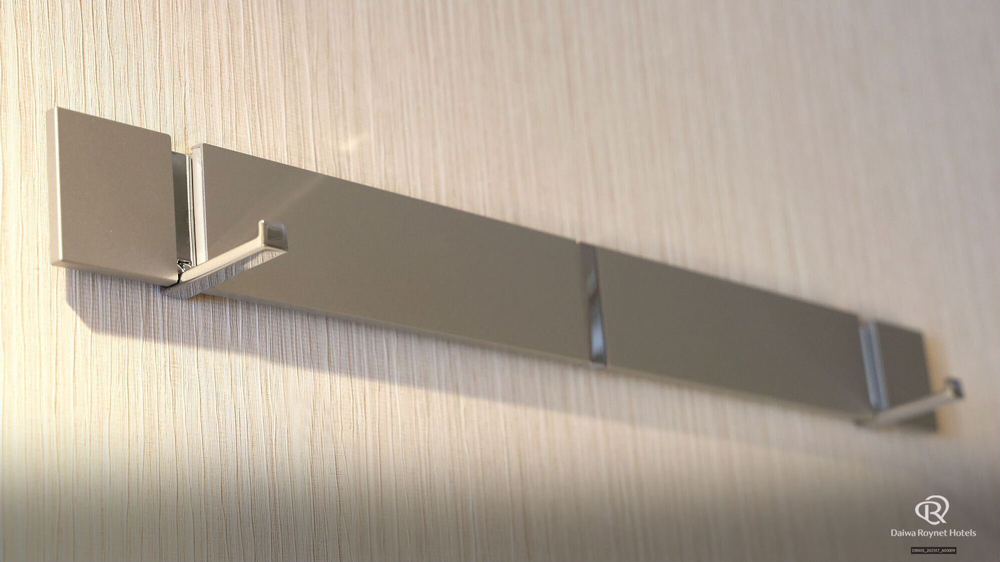 A wall-mounted light fixture with a minimalist design.