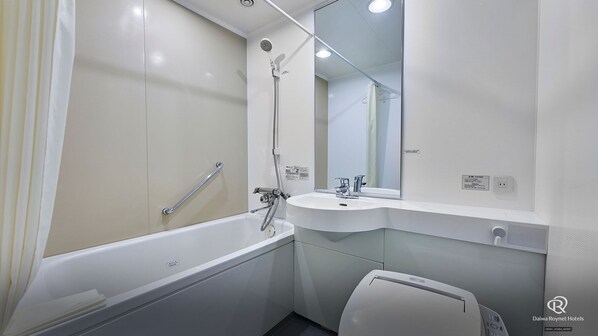 A modern bathroom with a bathtub, a sink, and a toilet.