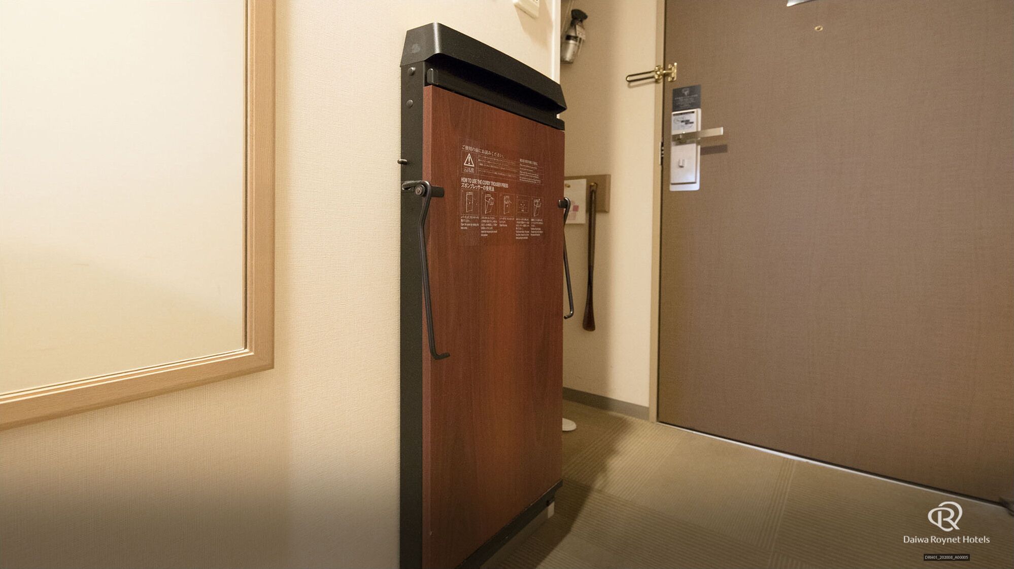 A corridor with a wooden door and a brown wall.