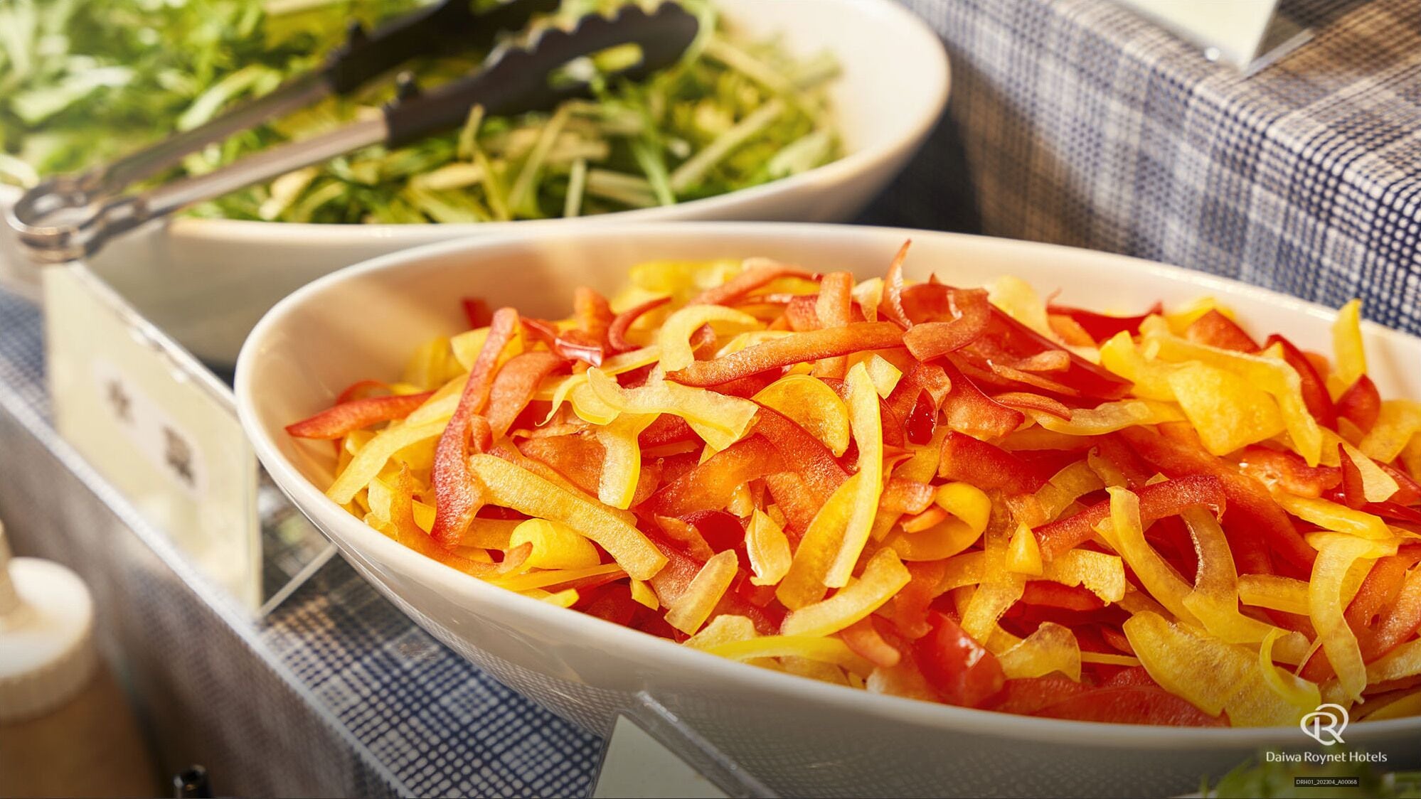 A bowl of sliced bell peppers on a table.