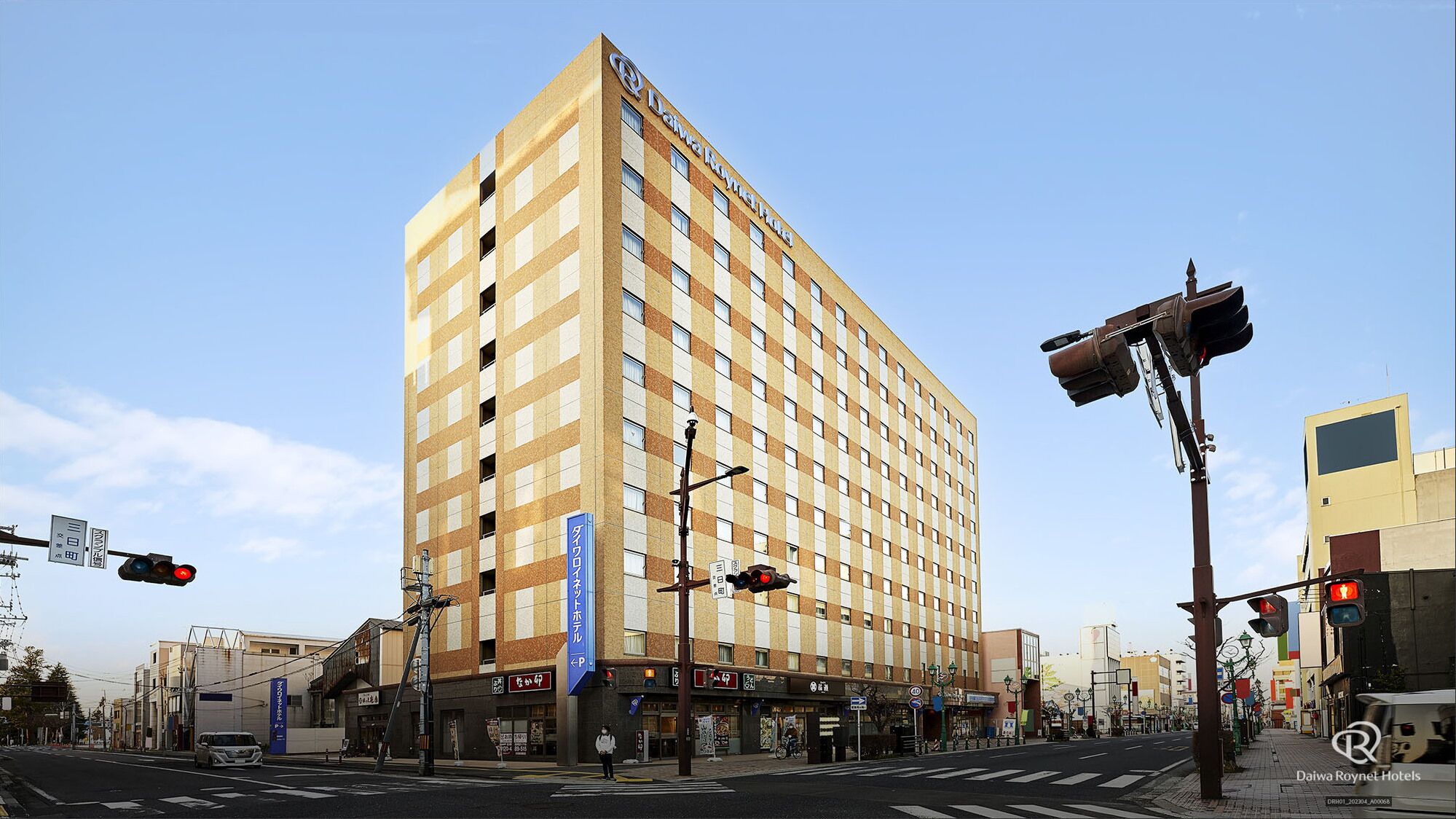 A tall hotel with a checkered facade, multiple floors, and a prominent signage for Daiwa Roynet Hotels.