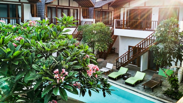 A resort with multiple two-story buildings, a swimming pool, and lush greenery. - Naturela Uluwatu (Pecatu)