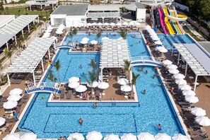 A large outdoor swimming pool with multiple lanes, sun loungers, umbrellas, and a children's water slide. - Karmir Resort & Spa - Ultra All Inclusive (Kemer)