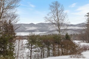 A snowy landscape with mountains in the background and trees in the foreground. - The Mountain Top Inn & Resort (Chittenden)