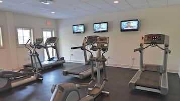 A fitness center with treadmills, elliptical machines, and stationary bikes.