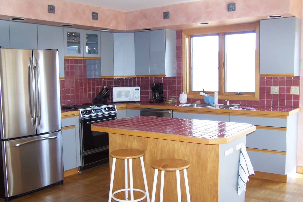Sunrise Retreat | Private kitchen | Fridge, cleaning supplies, paper towels