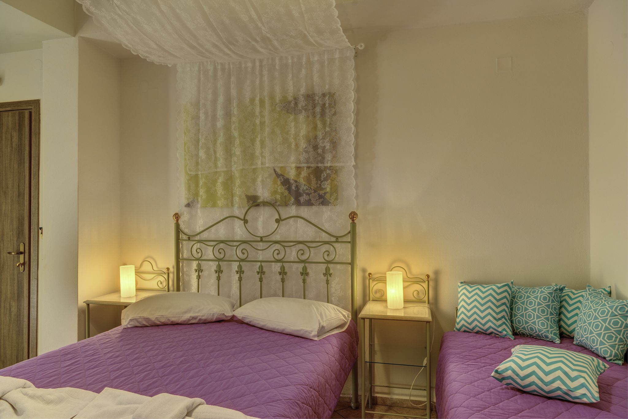 A bedroom with a bed, two bedside tables, and a nightstand.