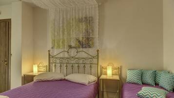 A bedroom with a bed, two bedside tables, and a nightstand.