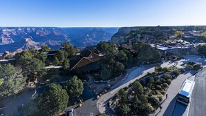 An aerial view of a resort with a road, buildings, and a canyon in the background.