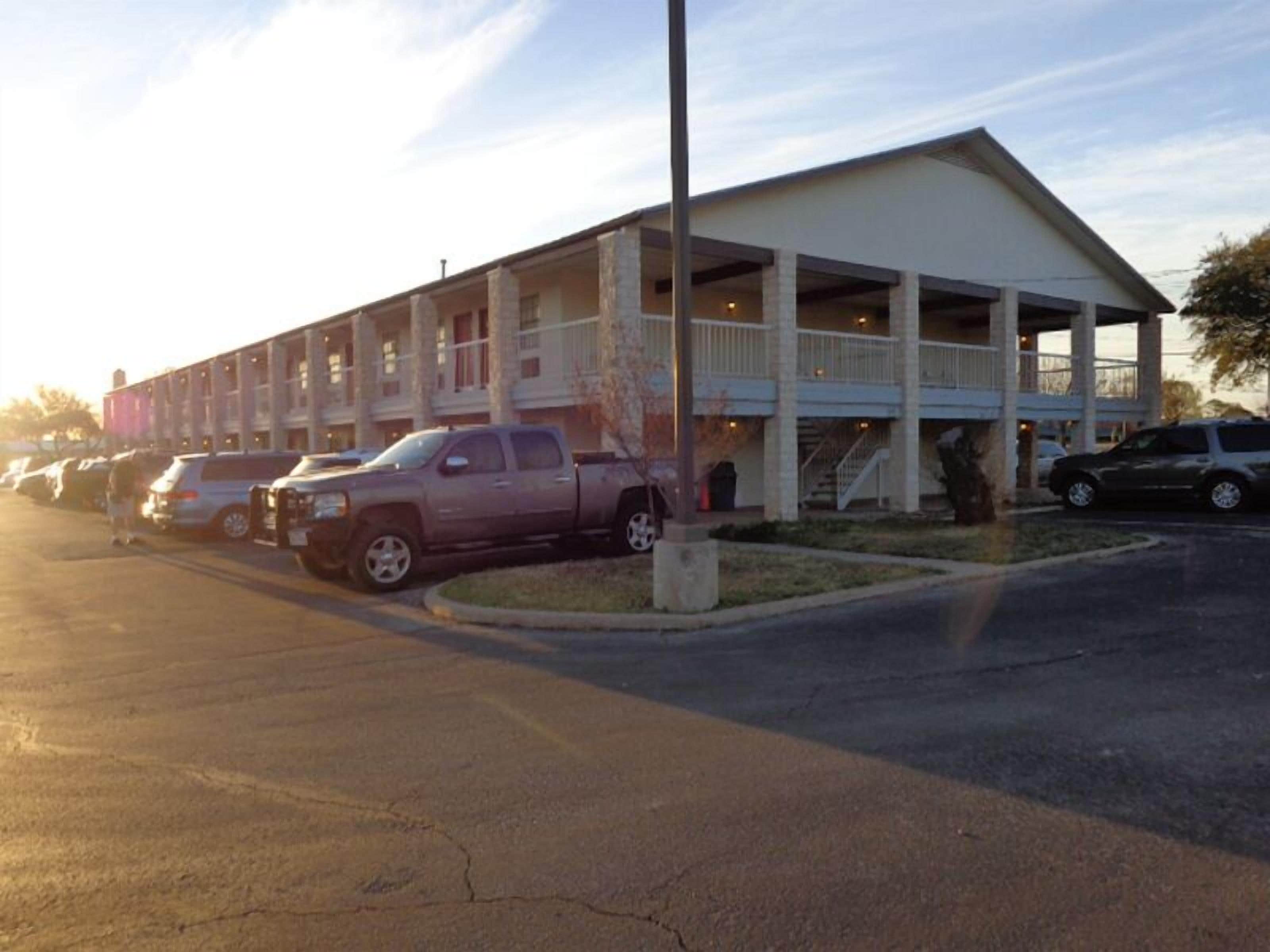 A building with a covered parking area and multiple levels.