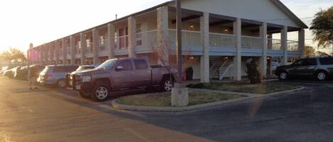 A building with a covered parking area and multiple levels.