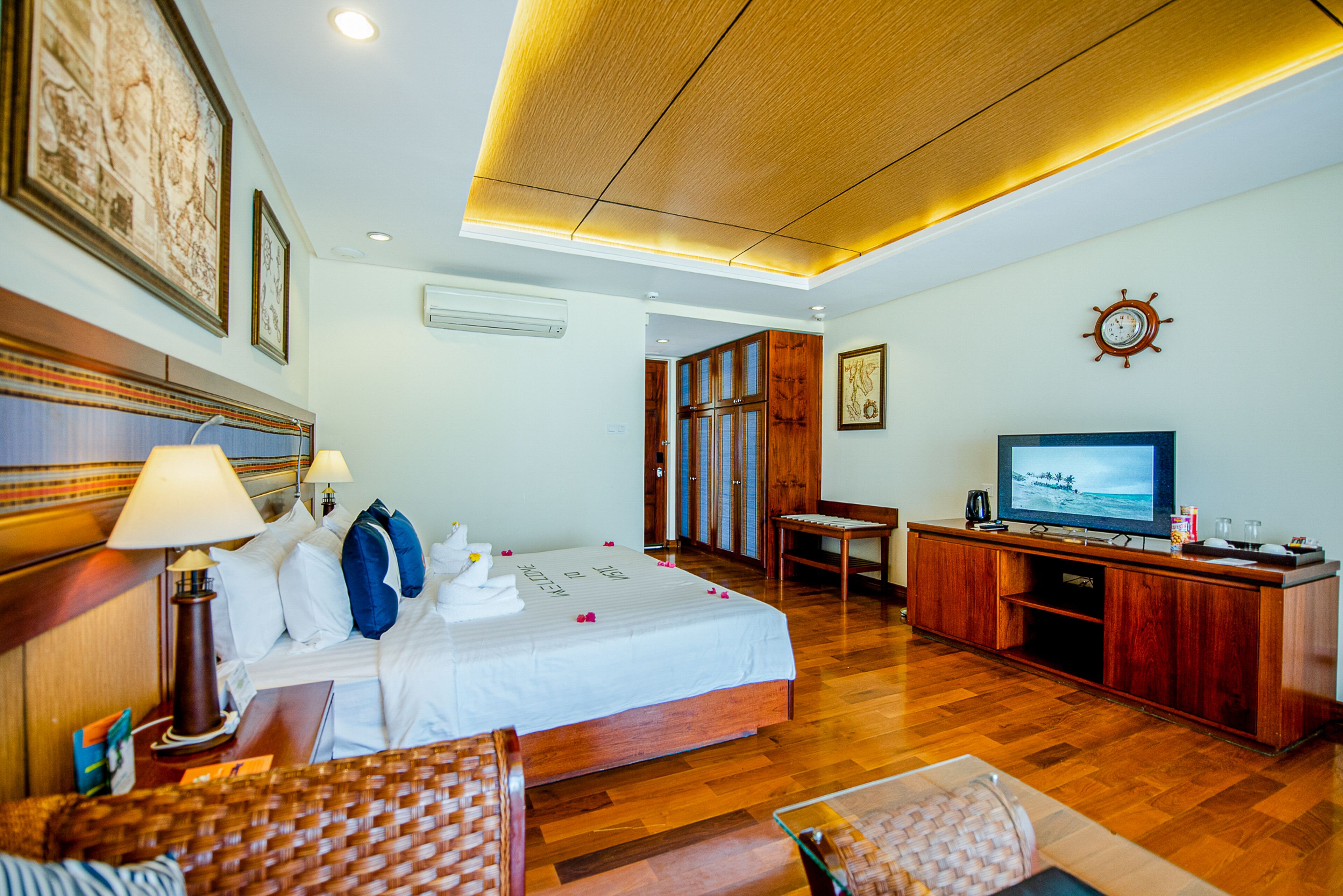 A hotel room with a bed, a television, a desk, and a chair.