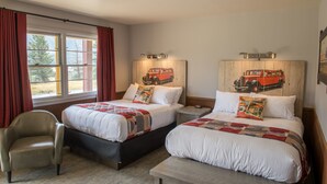 A hotel room with two beds, a chair, and a window with curtains. - Rising Sun Motor Inn and Cabins - Inside the Park (East Glacier Park)