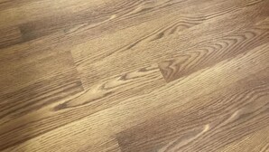 A close-up of a wooden floor with a natural grain pattern. - Lincoln Lodge (Urbana)