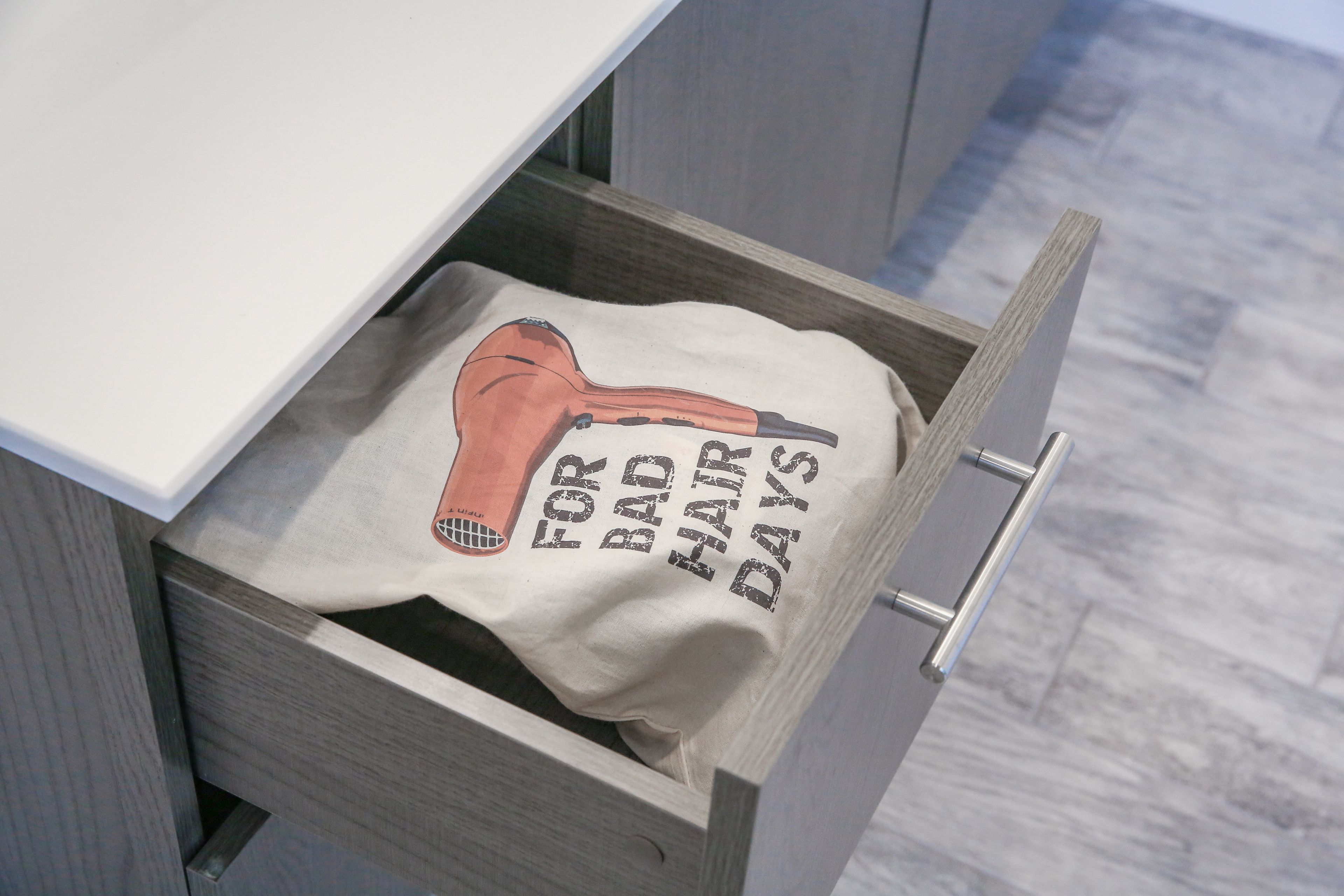 A drawer with a towel featuring a humorous design.