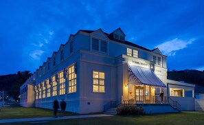 A large, two-story building with a dining room and lounge area, featuring large windows and a covered entrance. - Mammoth Hot Springs & Cabins - Inside the Park (Yellowstone National Park)