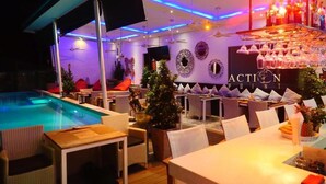 Eine Poolbar mit Sitzgelegenheiten und einem Schwimmbecken.