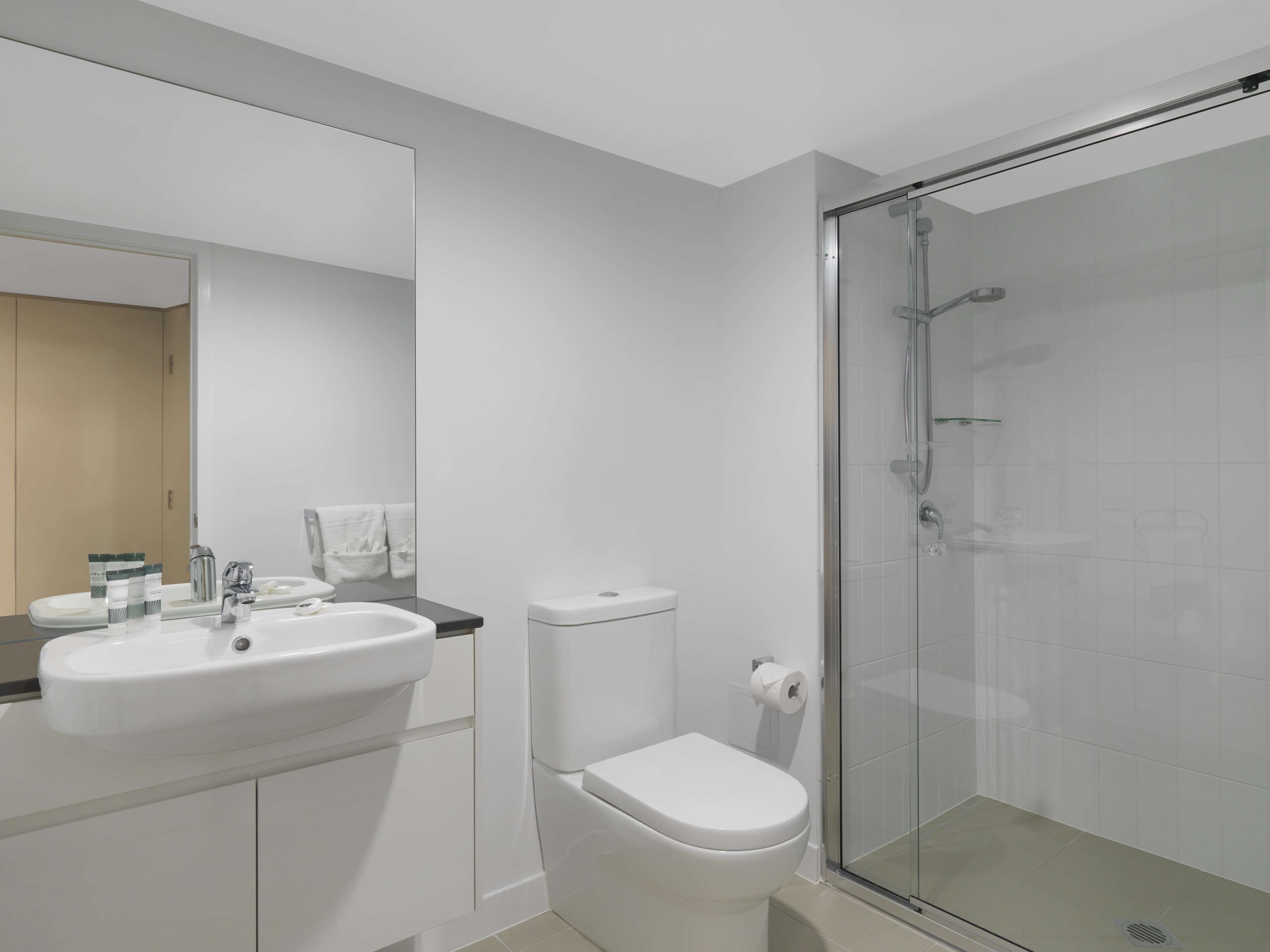 shower, hair dryer, towels, shampoo