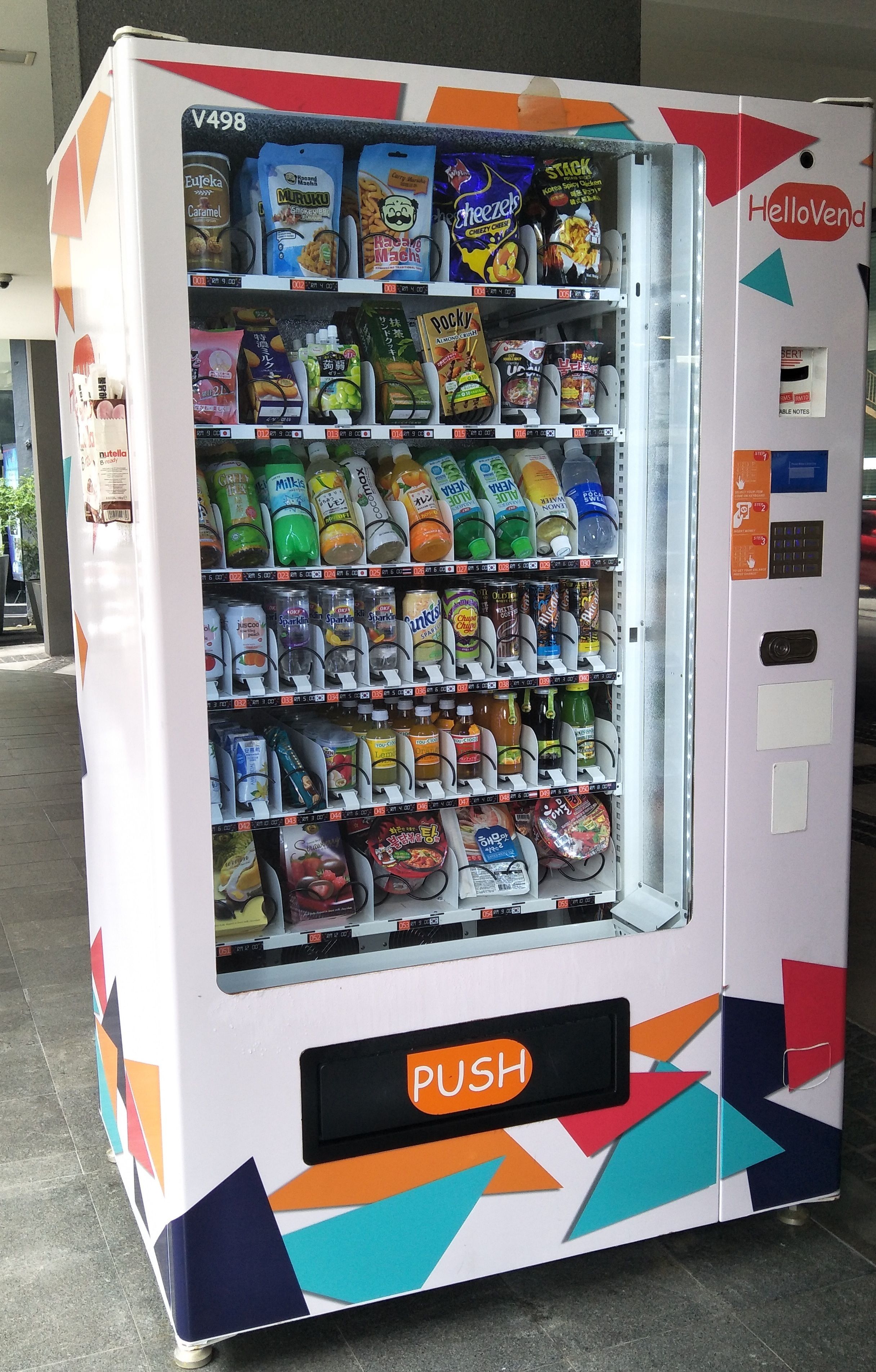 A vending machine with a colorful design, labeled "HelloVend," and a "PUSH" button.