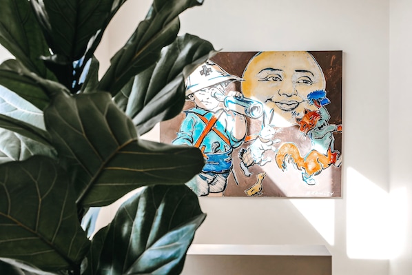 A framed artwork adorns the wall, featuring a person and their dog.