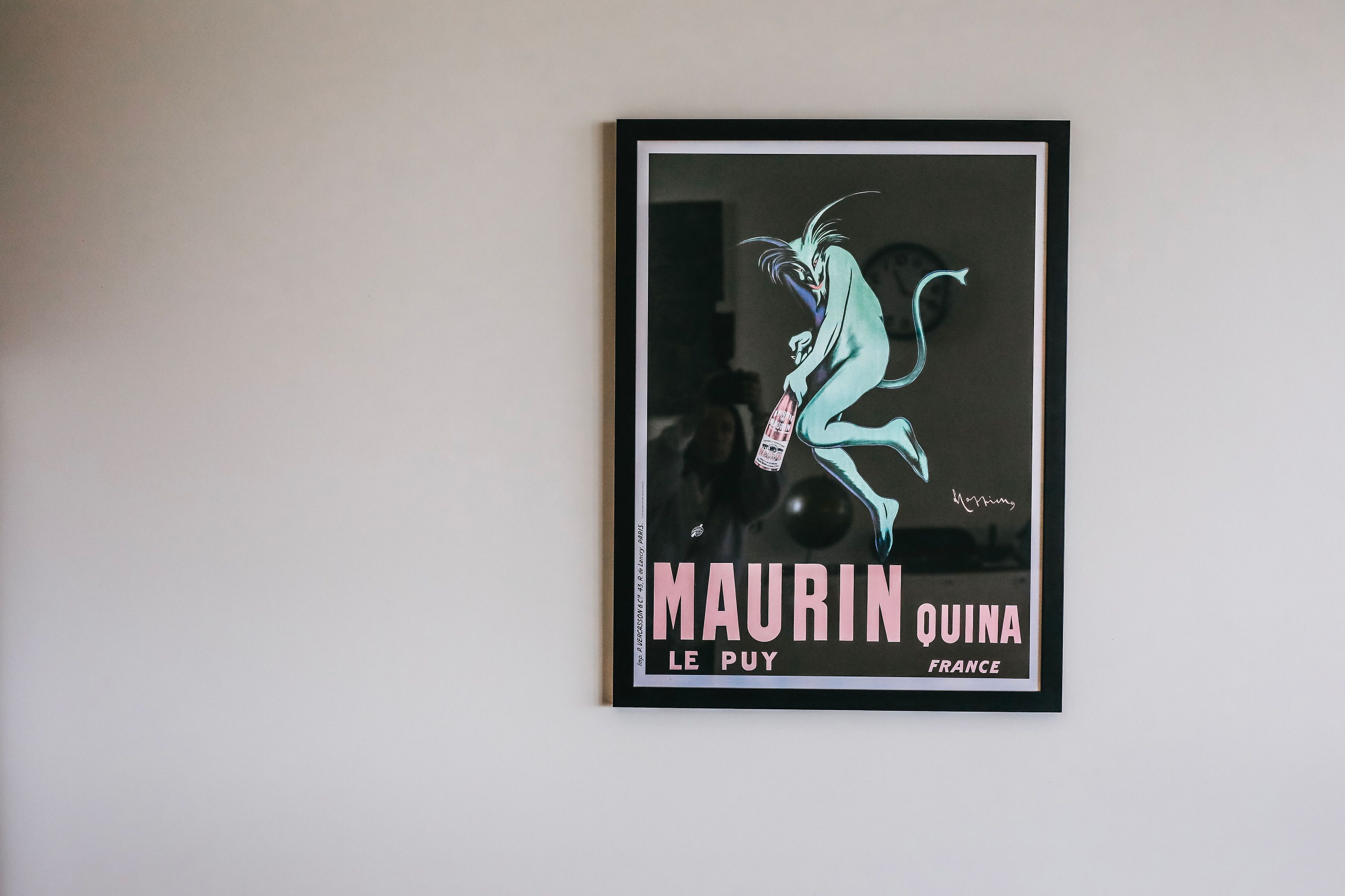 A framed poster of a cartoon character on a wall.