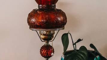 A table with a decorative lamp and a potted plant.