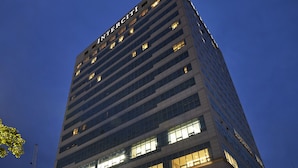 A high-rise building with the name "INTERCITY" prominently displayed. It features multiple floors with illuminated windows and a well-lit entrance area. - Hotel Interciti (Daejeon)