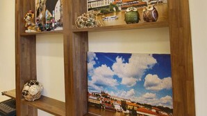 A wall with wooden beams and three framed pictures depicting European architecture and landscapes. - Soft Travel Hostel (Taitung)