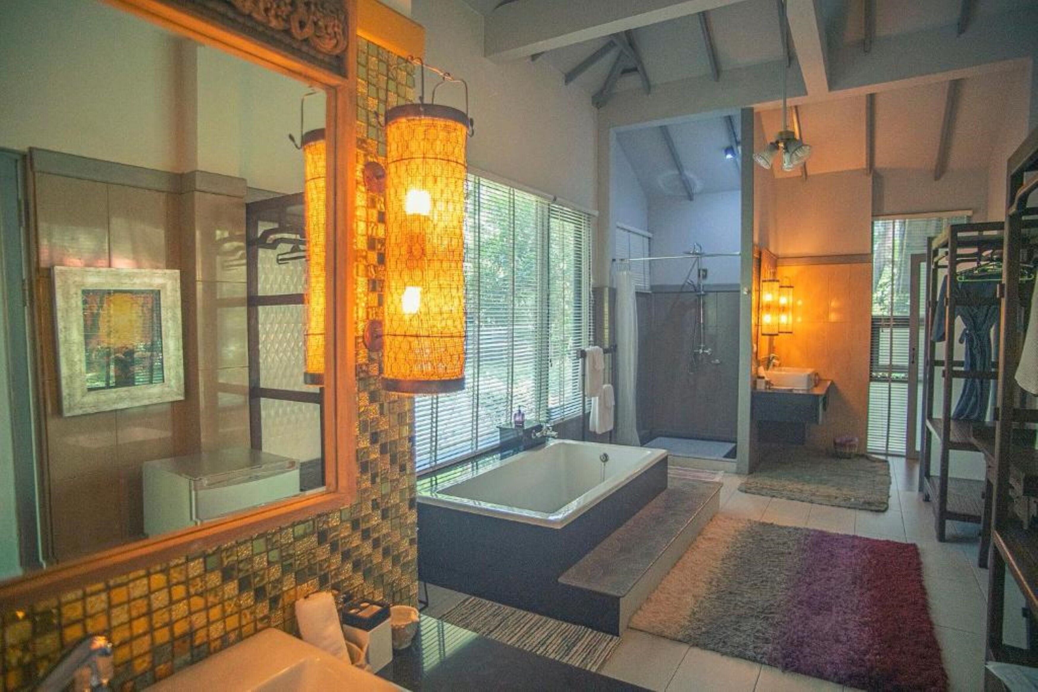 Ein modernes Badezimmer mit einer großzügigen Badewanne, einer begehbaren Dusche und einem separaten Waschbeckenbereich.