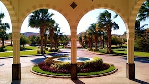 A covered outdoor area with palm trees and a central fountain, surrounded by well-maintained gardens. - The Oberoi, Sahl Hasheesh (Hurghada)