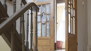 A staircase with wooden railings and a chandelier.